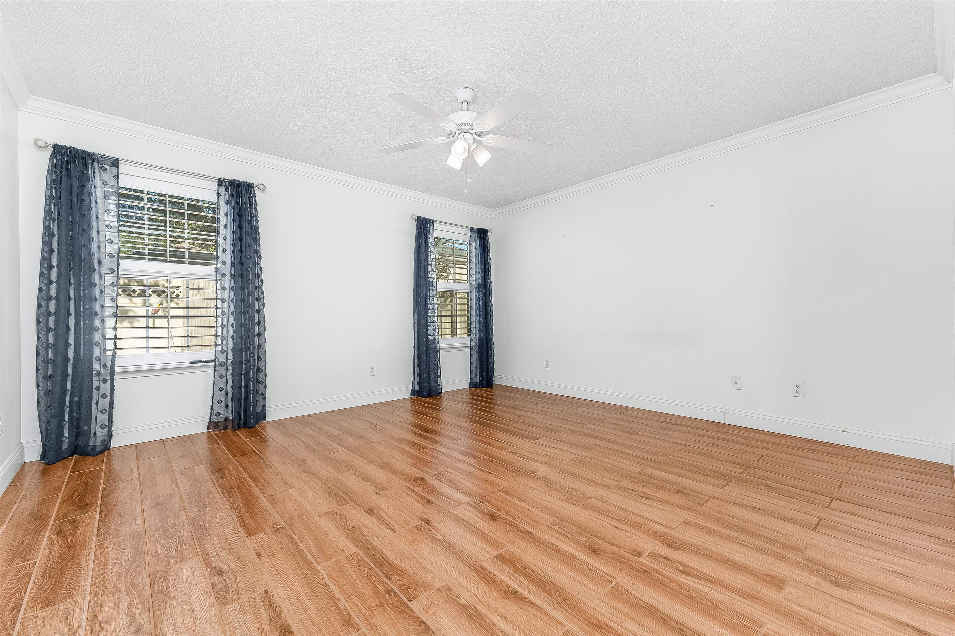 1236 Splendid Ravine Street St. Augustine, FL 32092 - Photo 29 of 47 a view of an empty room with wooden floor and a window