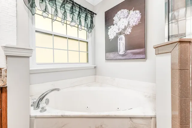 a white bath tub sitting next to a window