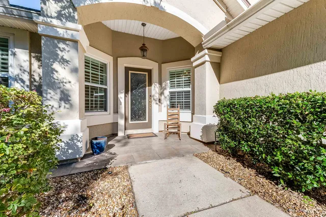 a view of a house with brick walls and potted plants