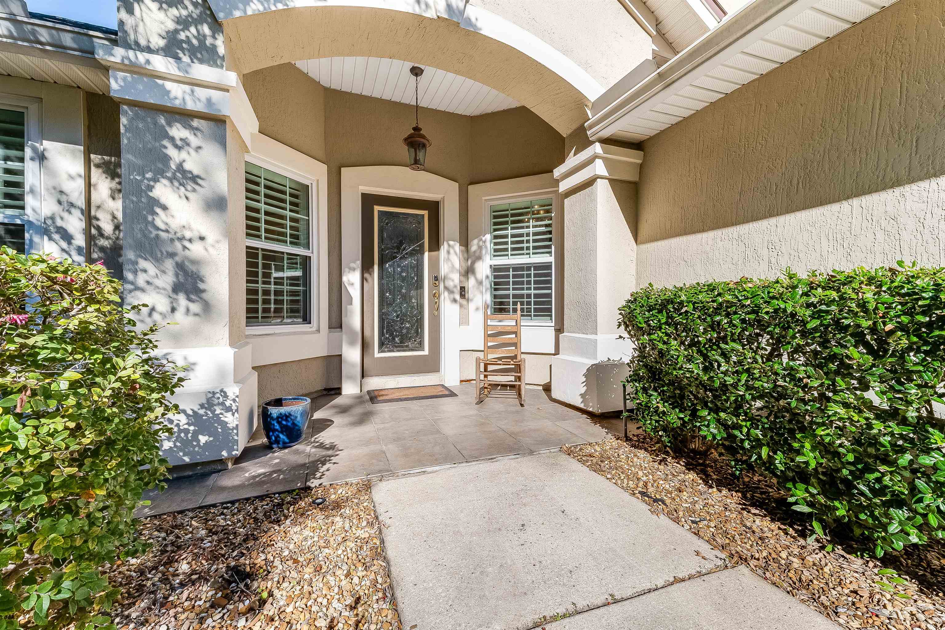 1236 Splendid Ravine Street St. Augustine, FL 32092 - Photo 5 of 47 a view of a house with brick walls and potted plants