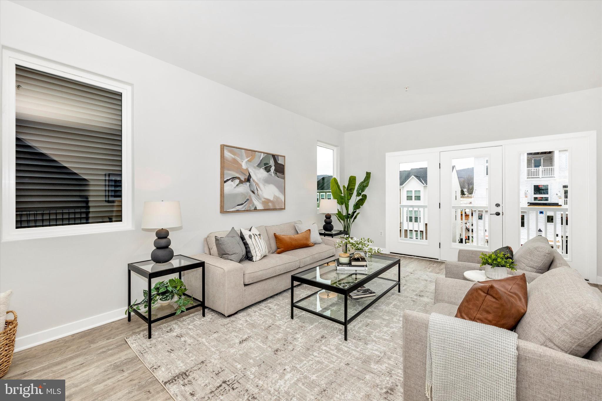 709 Iron Frg Road, Unit B Frederick, MD 21702 - Photo 11 of 32 a living room with furniture and wooden floor