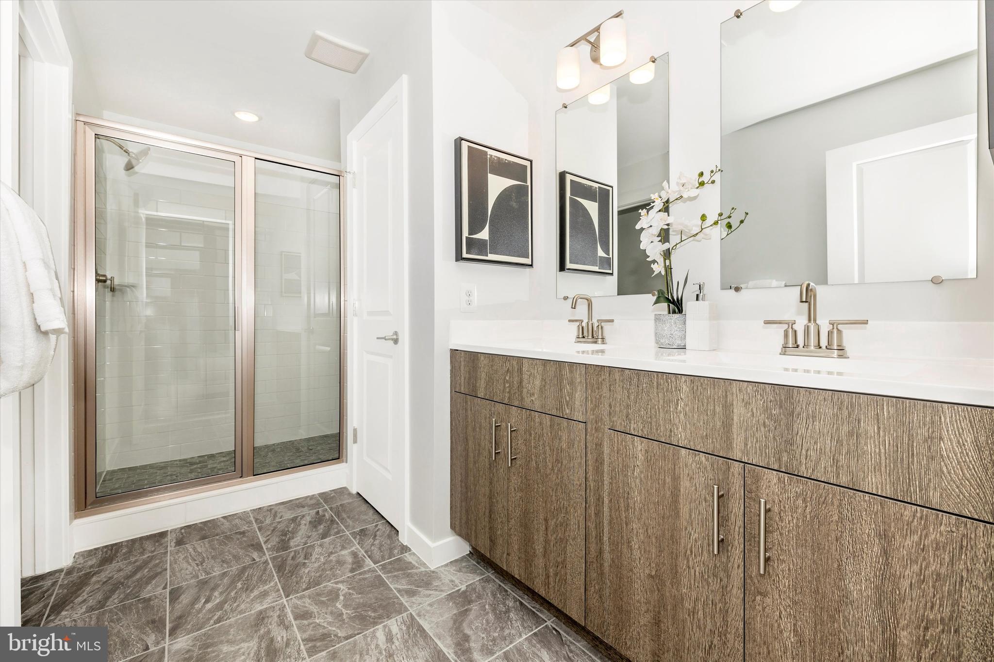 709 Iron Frg Road, Unit B Frederick, MD 21702 - Photo 26 of 32 a bathroom with double vanity sink and a mirror