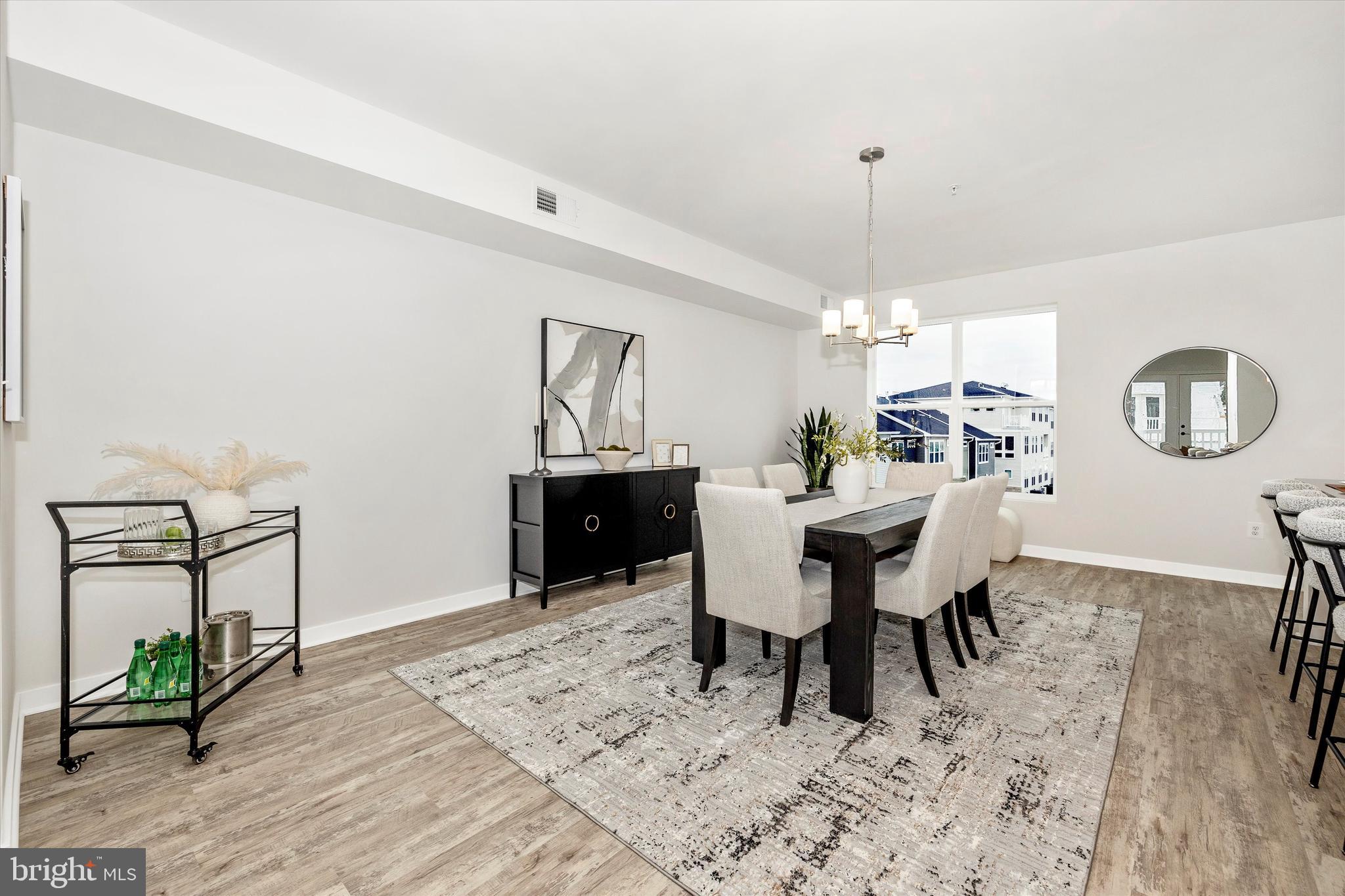 709 Iron Frg Road, Unit B Frederick, MD 21702 - Photo 6 of 32 a view of a dining room with furniture and wooden floor