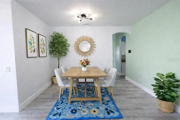 a view of a dining room with furniture and wooden floor