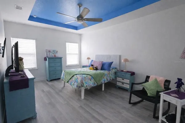 a bedroom with a bed and a chandelier