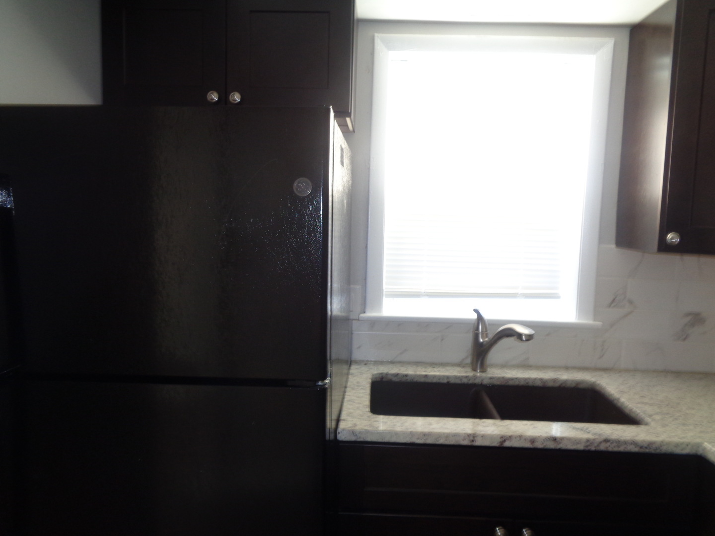 1340 North Main Street, Unit E1 Wheaton, IL 60187 - Photo 7 of 8 a bathroom with a sink and a window