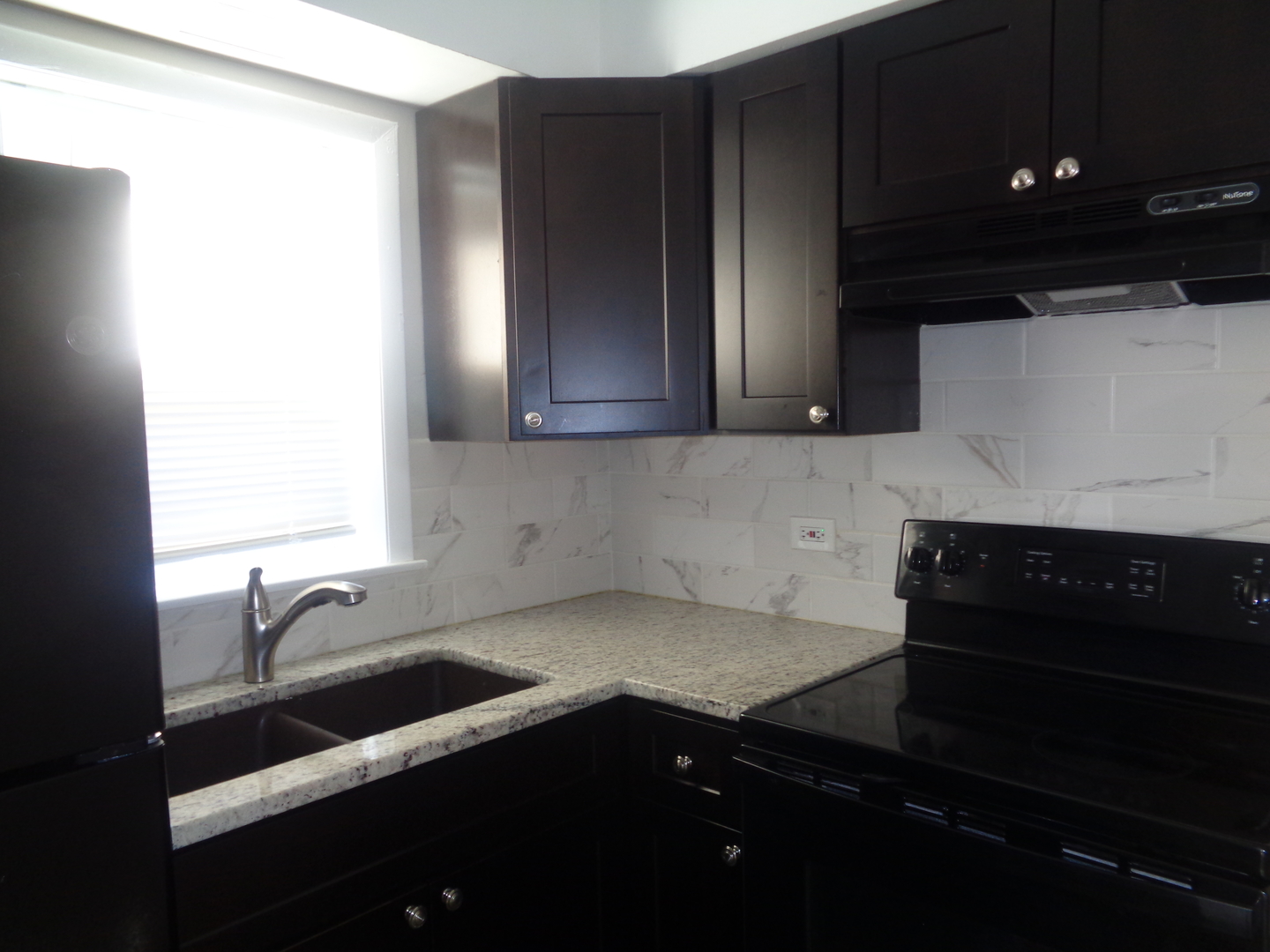 1340 North Main Street, Unit E1 Wheaton, IL 60187 - Photo 8 of 8 a kitchen with a sink and cabinets