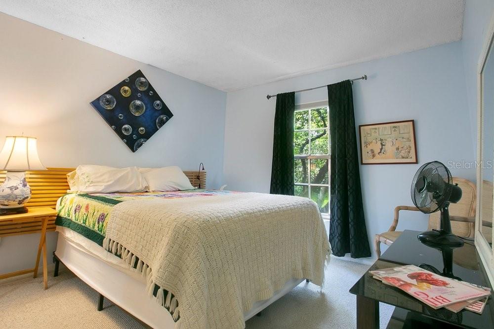 412 Forest Street Windermere, FL 34786 - Photo 15 of 34 a bedroom with a bed and dresser next to a window