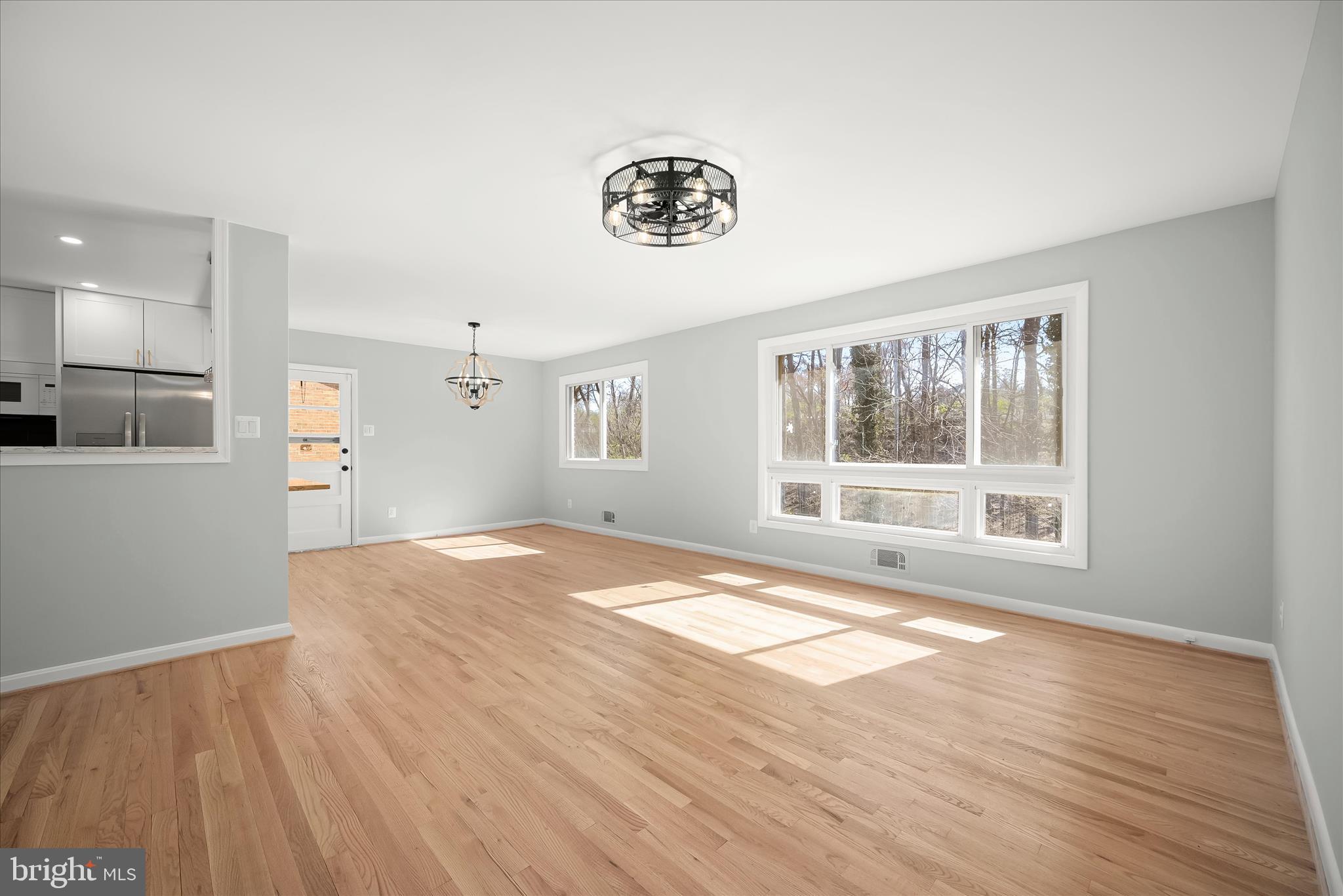 9720 Hedin Drive Silver Spring, MD 20903 - Photo 47 of 79 a view of an empty room with a window and wooden floor
