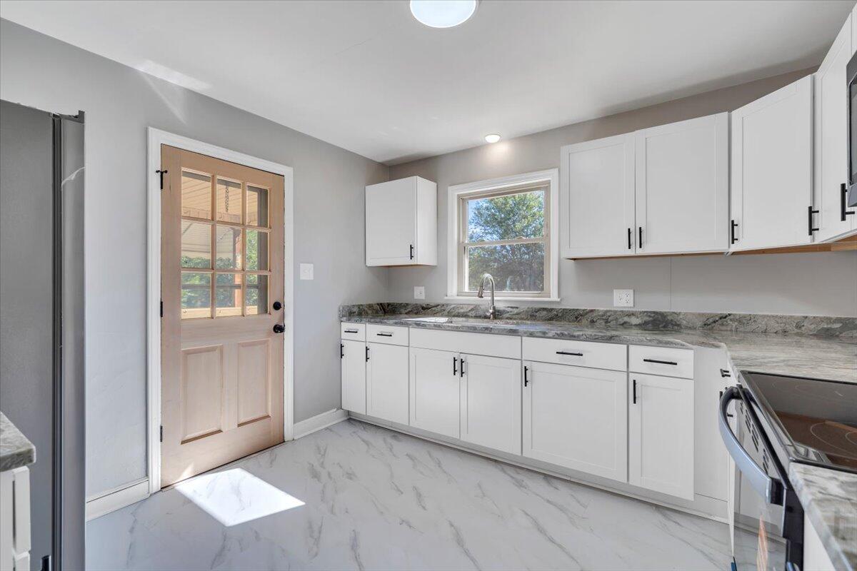 210 Post Road Roanoke, VA 24019 - Photo 11 of 56 a kitchen with granite countertop cabinets stainless steel appliances a sink and a window