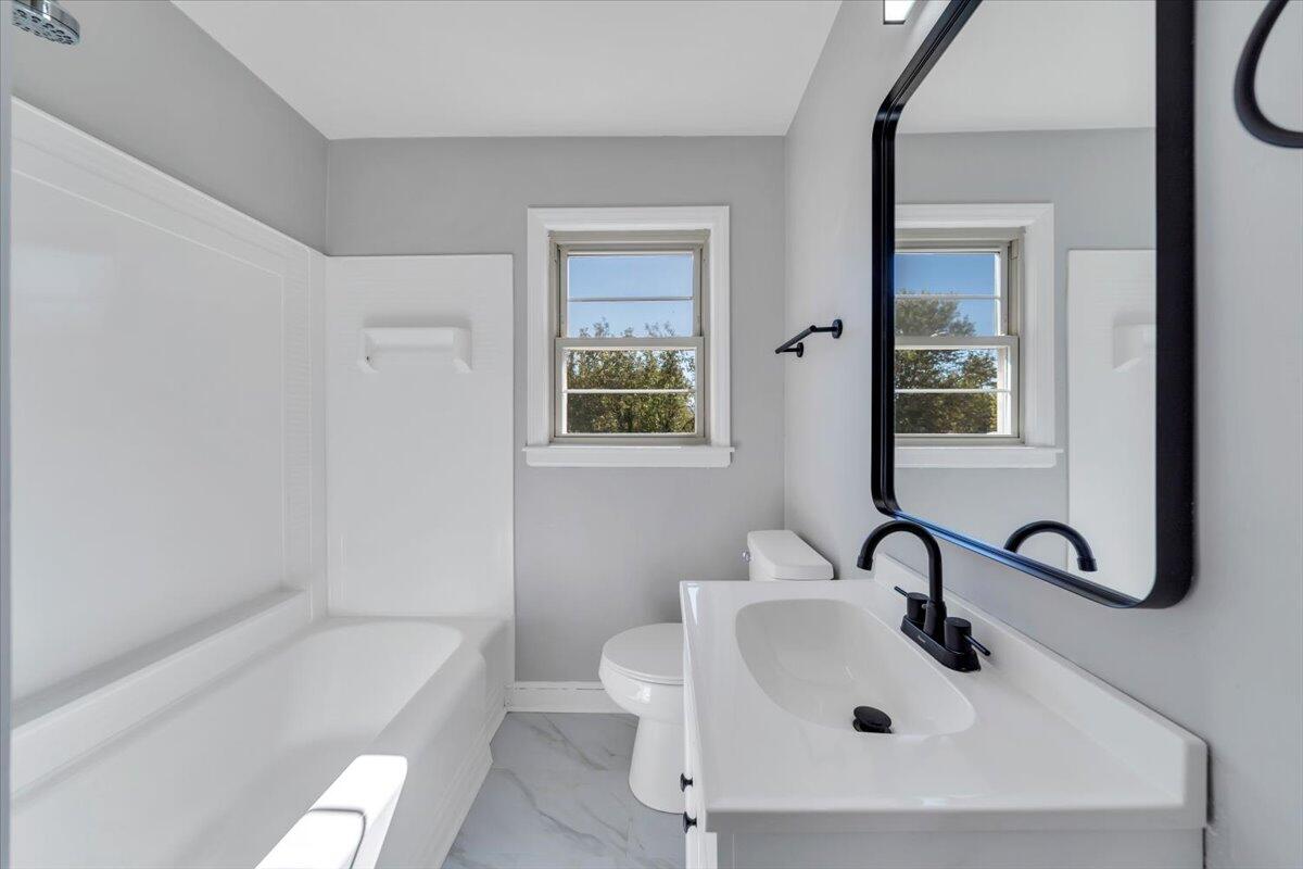 210 Post Road Roanoke, VA 24019 - Photo 16 of 56 a bathroom with a sink a toilet and bathtub