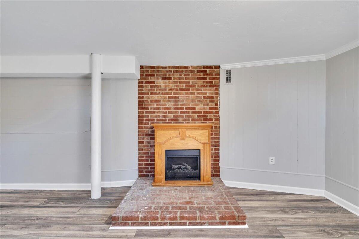 210 Post Road Roanoke, VA 24019 - Photo 25 of 56 a view of empty room with wooden floor and fireplace