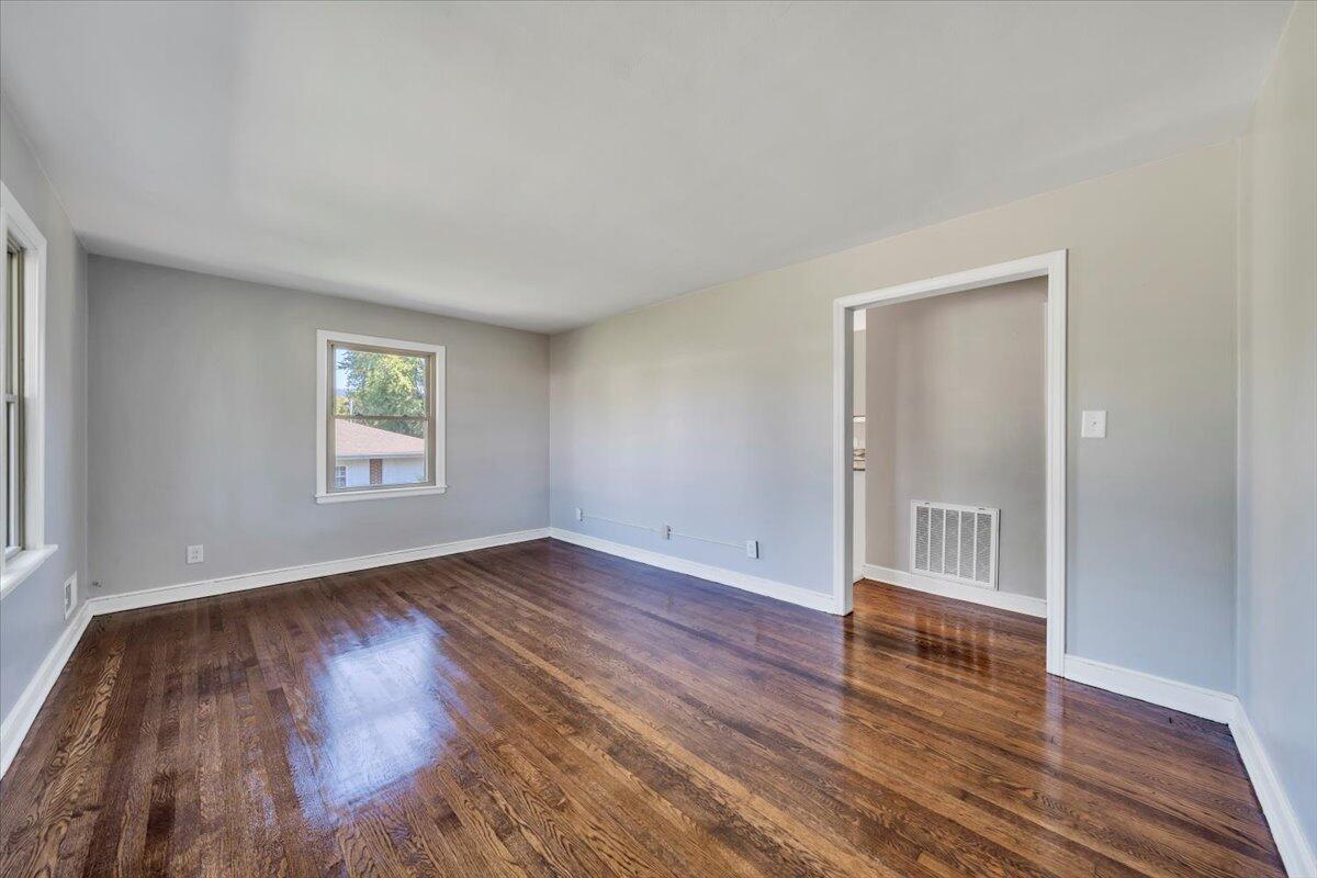 210 Post Road Roanoke, VA 24019 - Photo 3 of 56 an empty room with wooden floor and windows