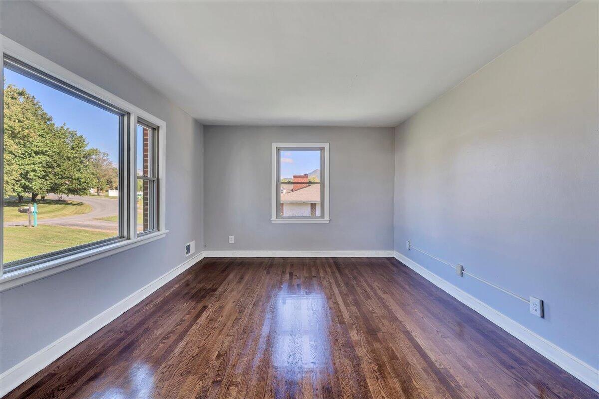 210 Post Road Roanoke, VA 24019 - Photo 4 of 56 a view of an empty room with wooden floor and a window