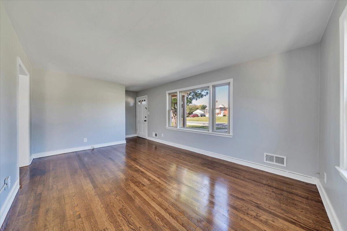210 Post Road Roanoke, VA 24019 - Photo 6 of 56 a view of an empty room with wooden floor and a window
