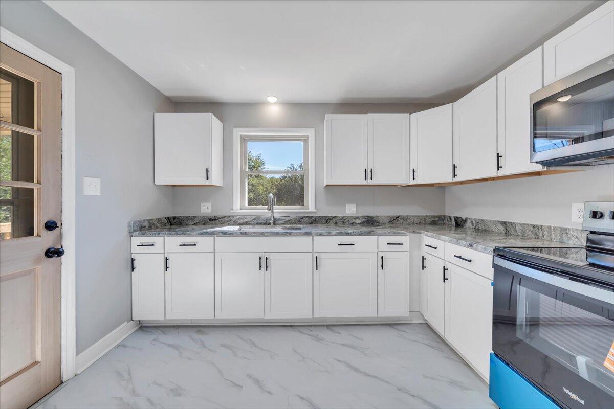 210 Post Road Roanoke, VA 24019 - Photo 8 of 56 a kitchen with granite countertop white cabinets sink and stainless steel appliances