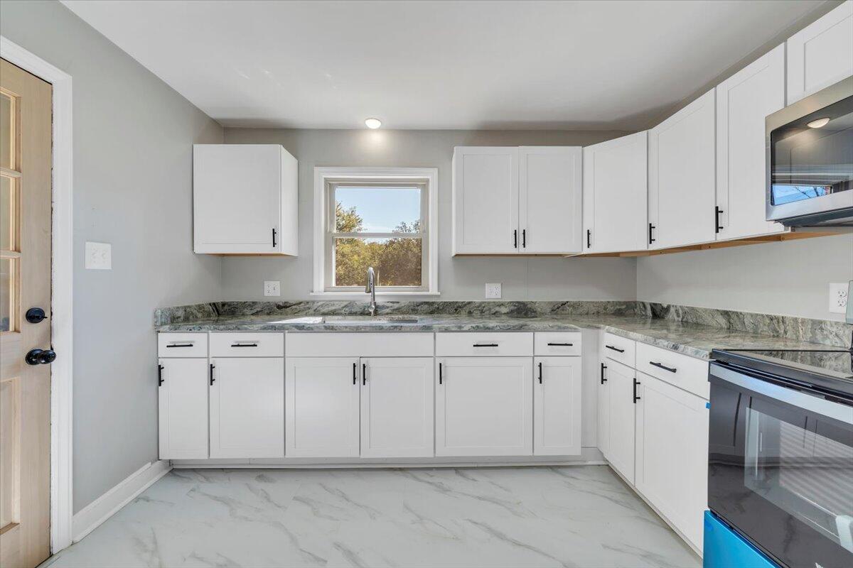 210 Post Road Roanoke, VA 24019 - Photo 9 of 56 a kitchen with granite countertop white cabinets white stainless steel appliances with a sink and dishwasher