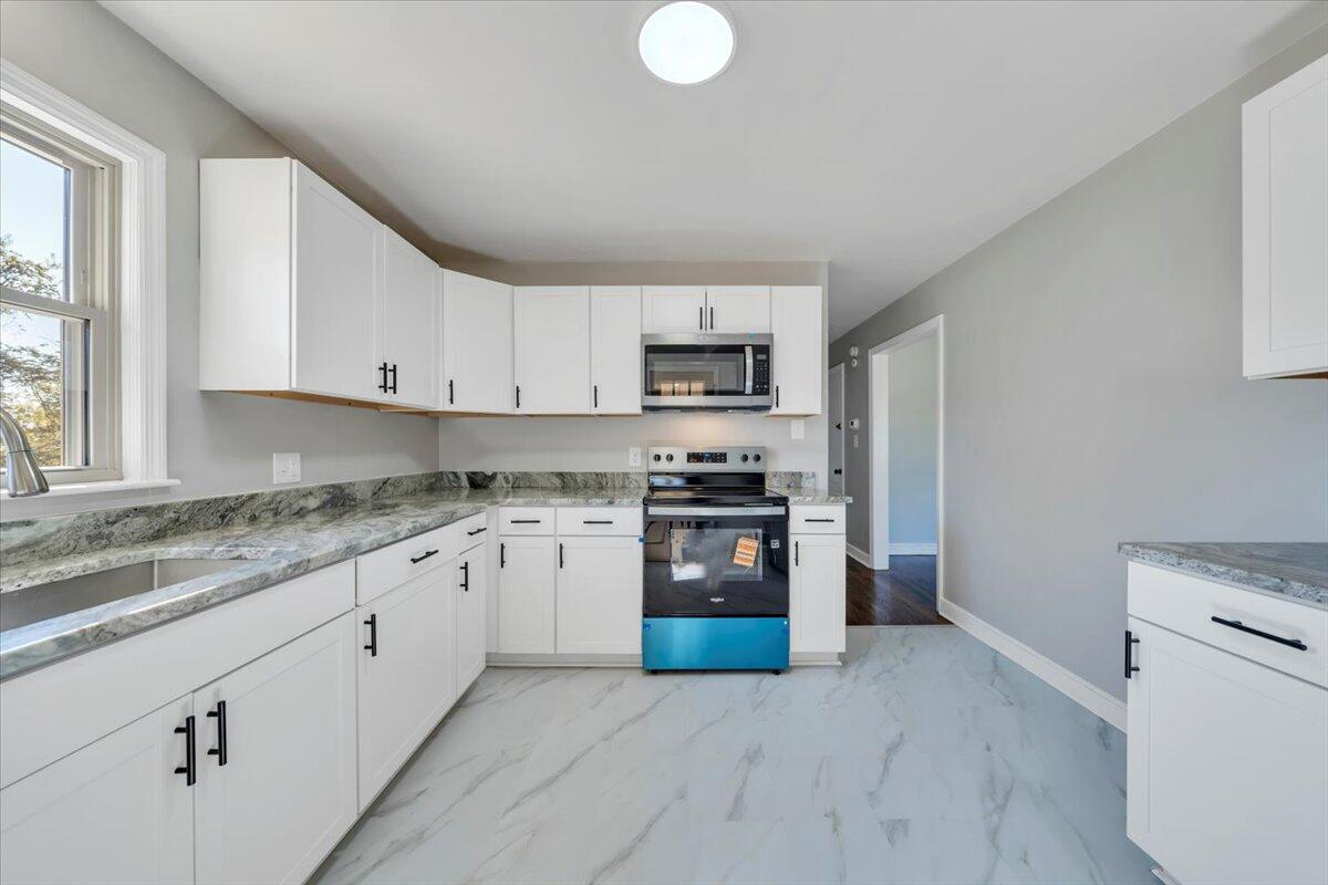 210 Post Road Roanoke, VA 24019 - Photo 10 of 56 a kitchen with granite countertop white cabinets and stainless steel appliances