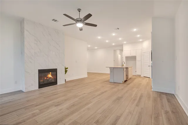 a view of empty room with window and fireplace