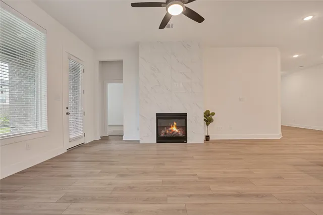 an empty room with chandelier fan