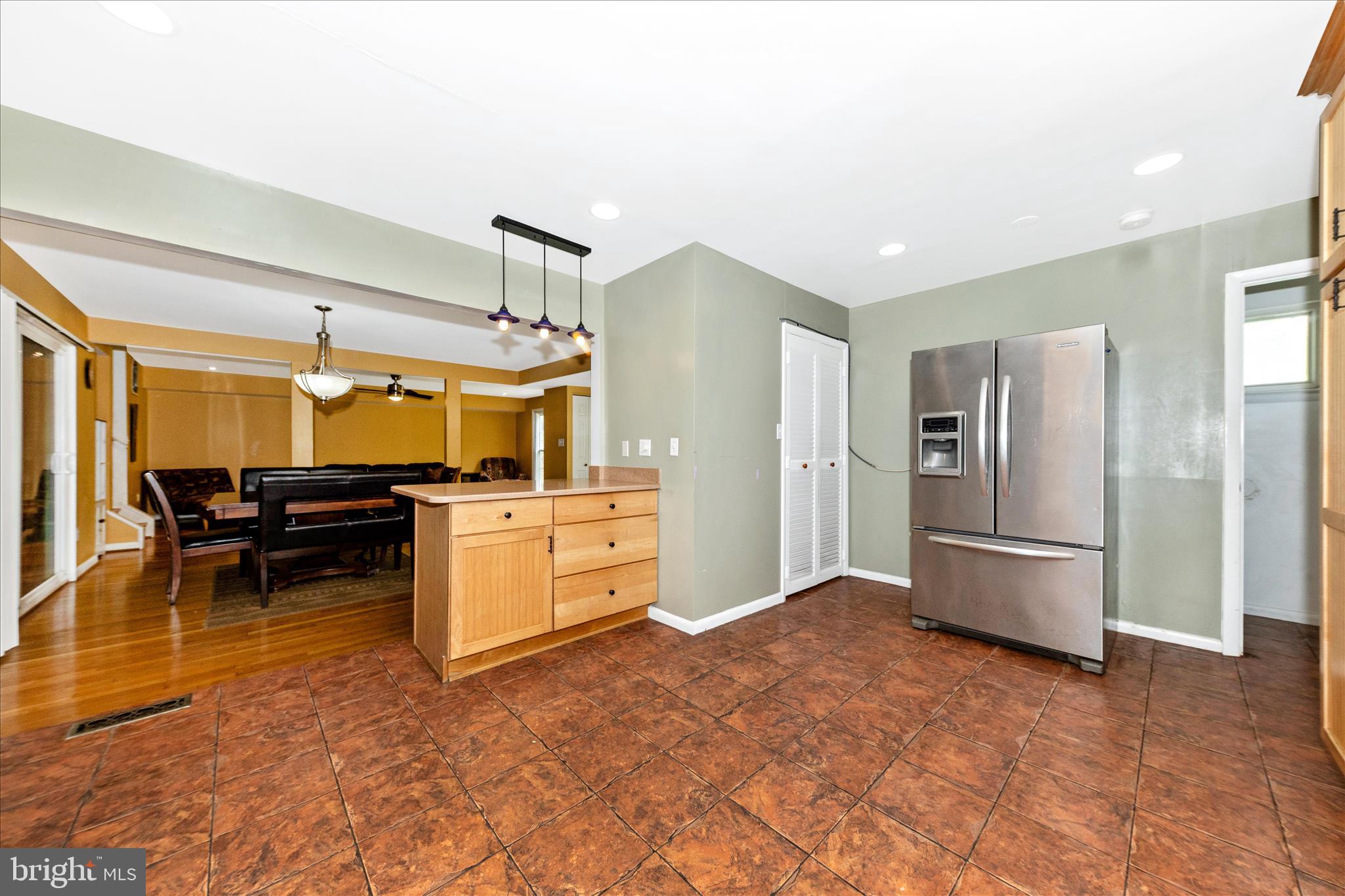 11412 Fairoak Drive Silver Spring, MD 20902 - Photo 14 of 48 a kitchen with refrigerator and cabinets