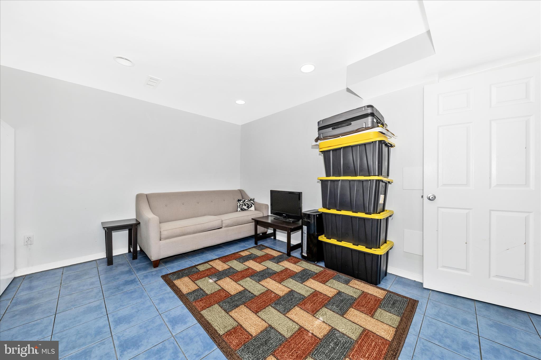 11412 Fairoak Drive Silver Spring, MD 20902 - Photo 31 of 48 a living room with a couch and a rug