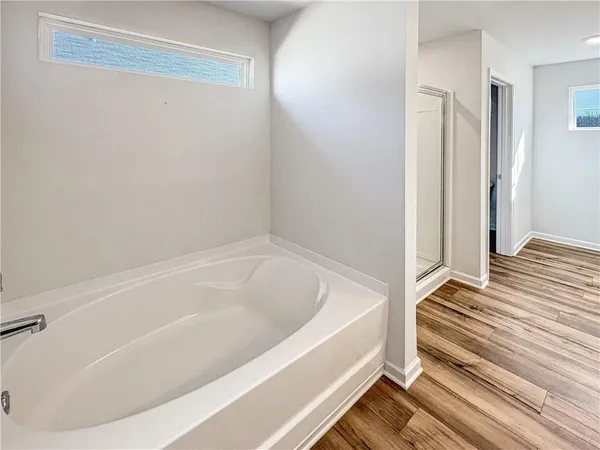 a bathroom with a bathtub and a shower