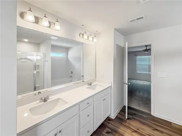 a spacious bathroom with a double vanity sink mirror and double