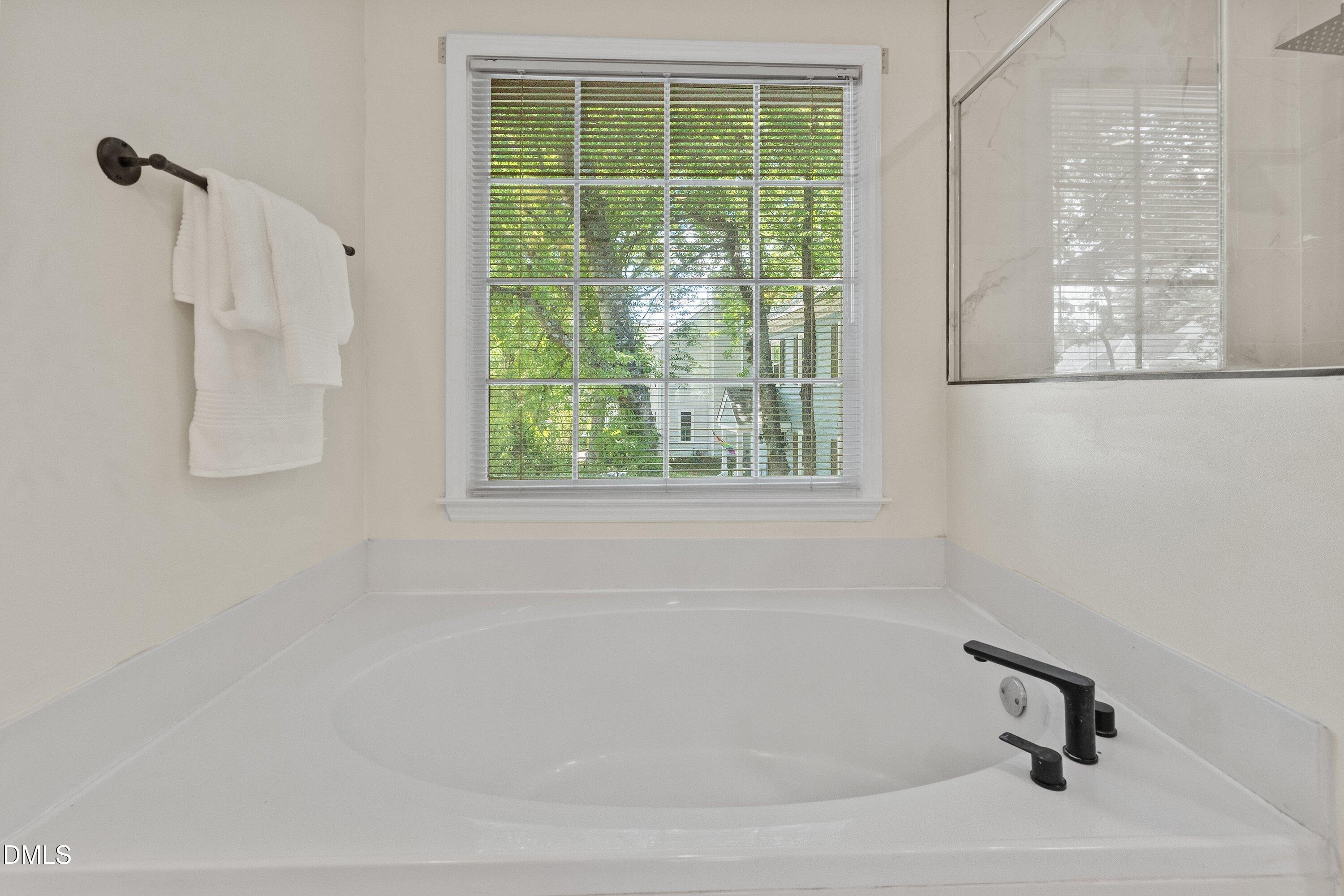 2517 Birchford Court Raleigh, NC 27604 - Photo 39 of 63 a white bath tub sitting next to a window