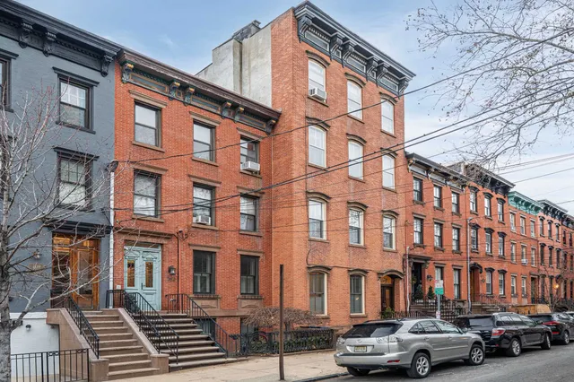 front view of a brick building with many windows