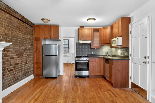 a kitchen with stainless steel appliances granite countertop a refrigerator and a sink