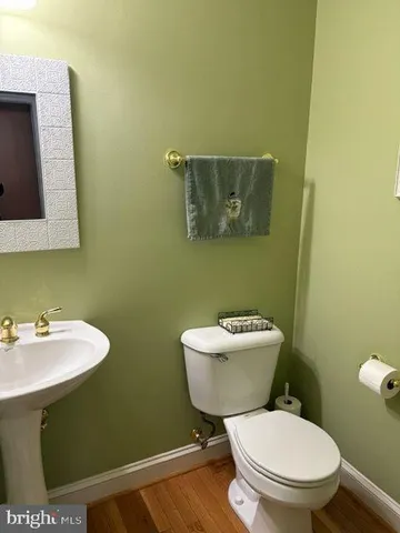 a bathroom with a toilet a sink and mirror