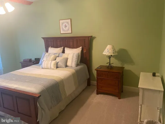 a large bed sitting in a bedroom and lamp