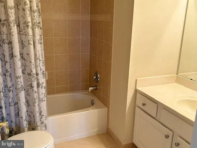 a white bath tub sitting next to a white toilet