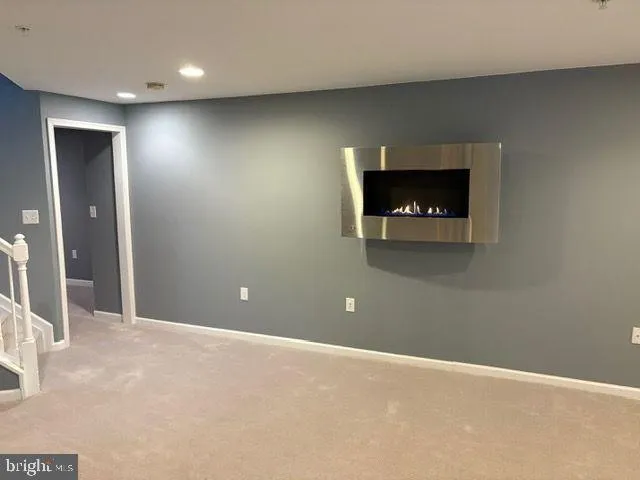a view of a livingroom with an empty space and a fireplace