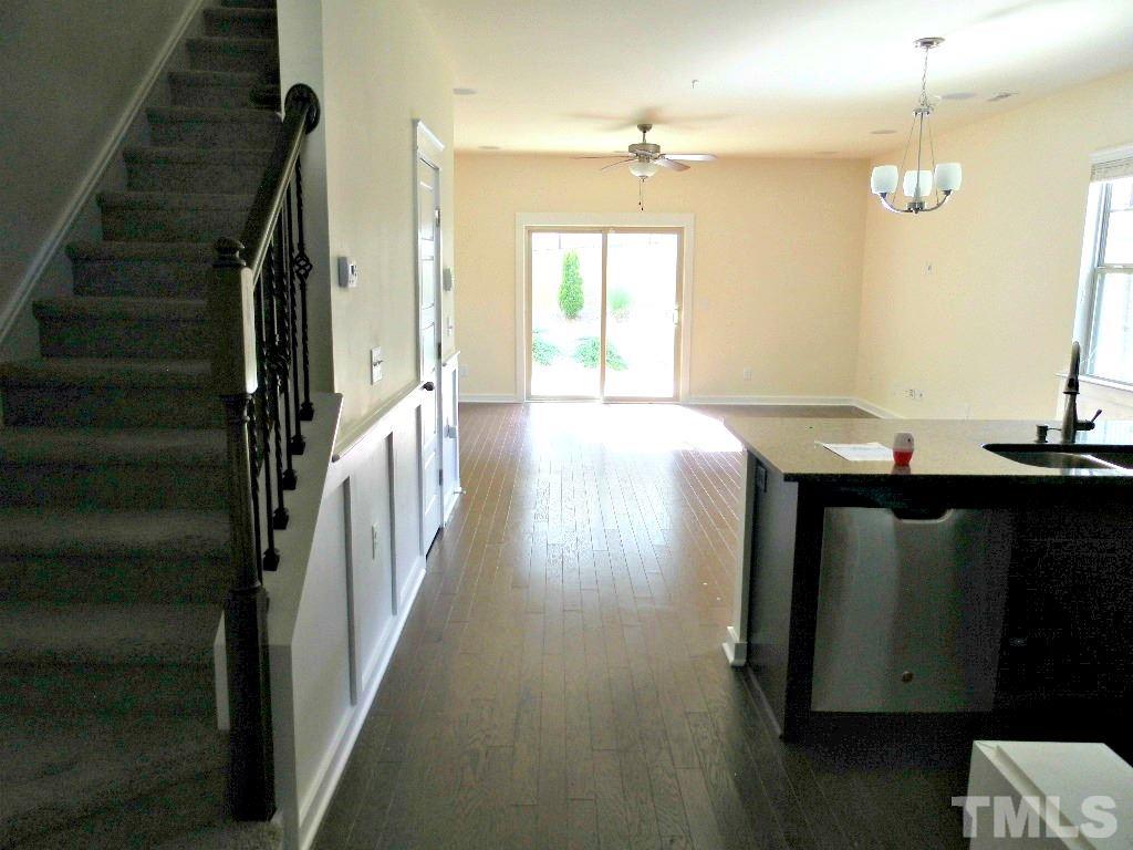 7828 Allscott Way Raleigh, NC 27612 - Photo 12 of 17 a view of a hallway with wooden floor and staircase
