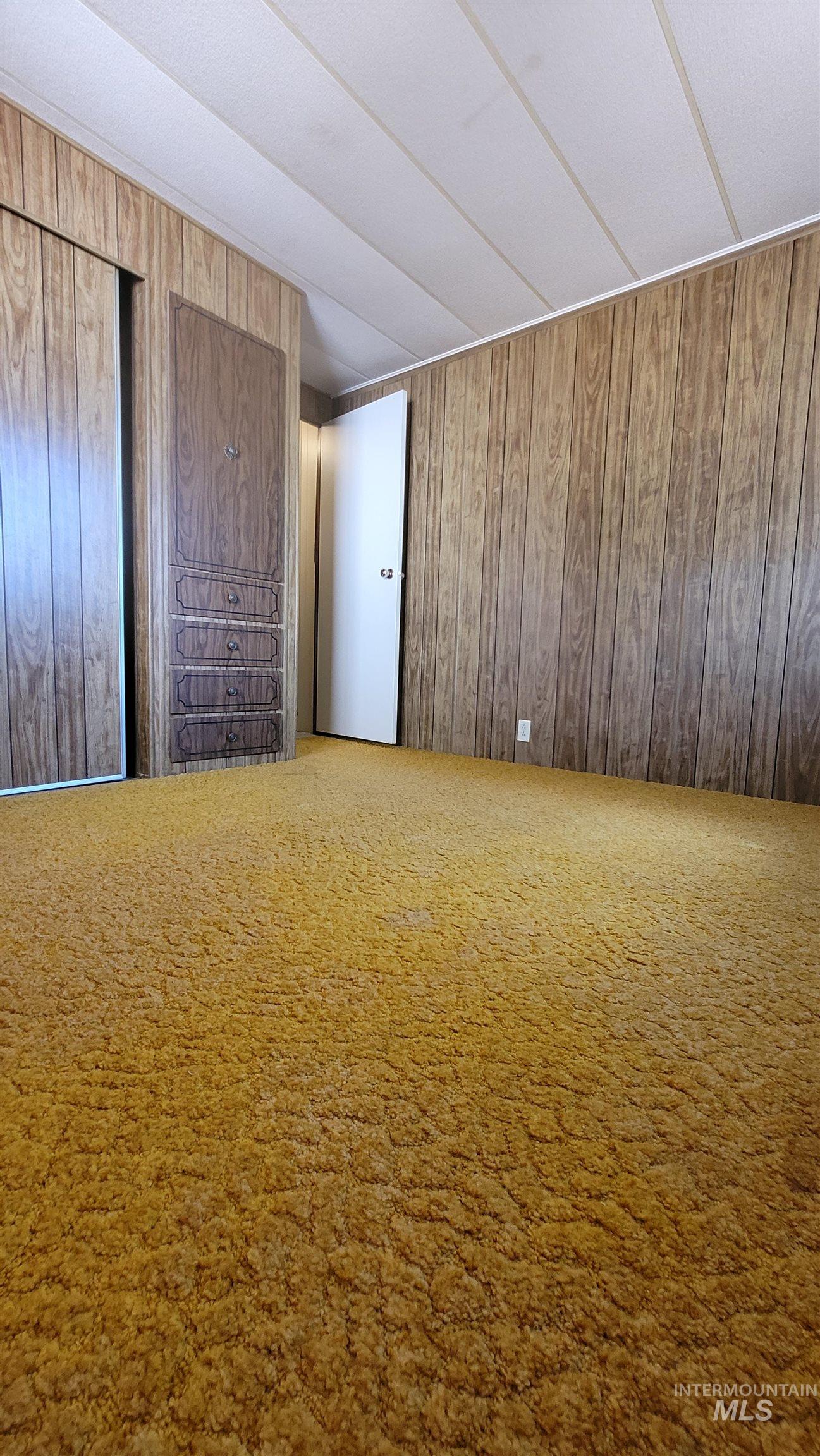 2122 Highway 95 Council, ID 83612 - Photo 15 of 31 Unfurnished bedroom featuring wood walls and carpet floors