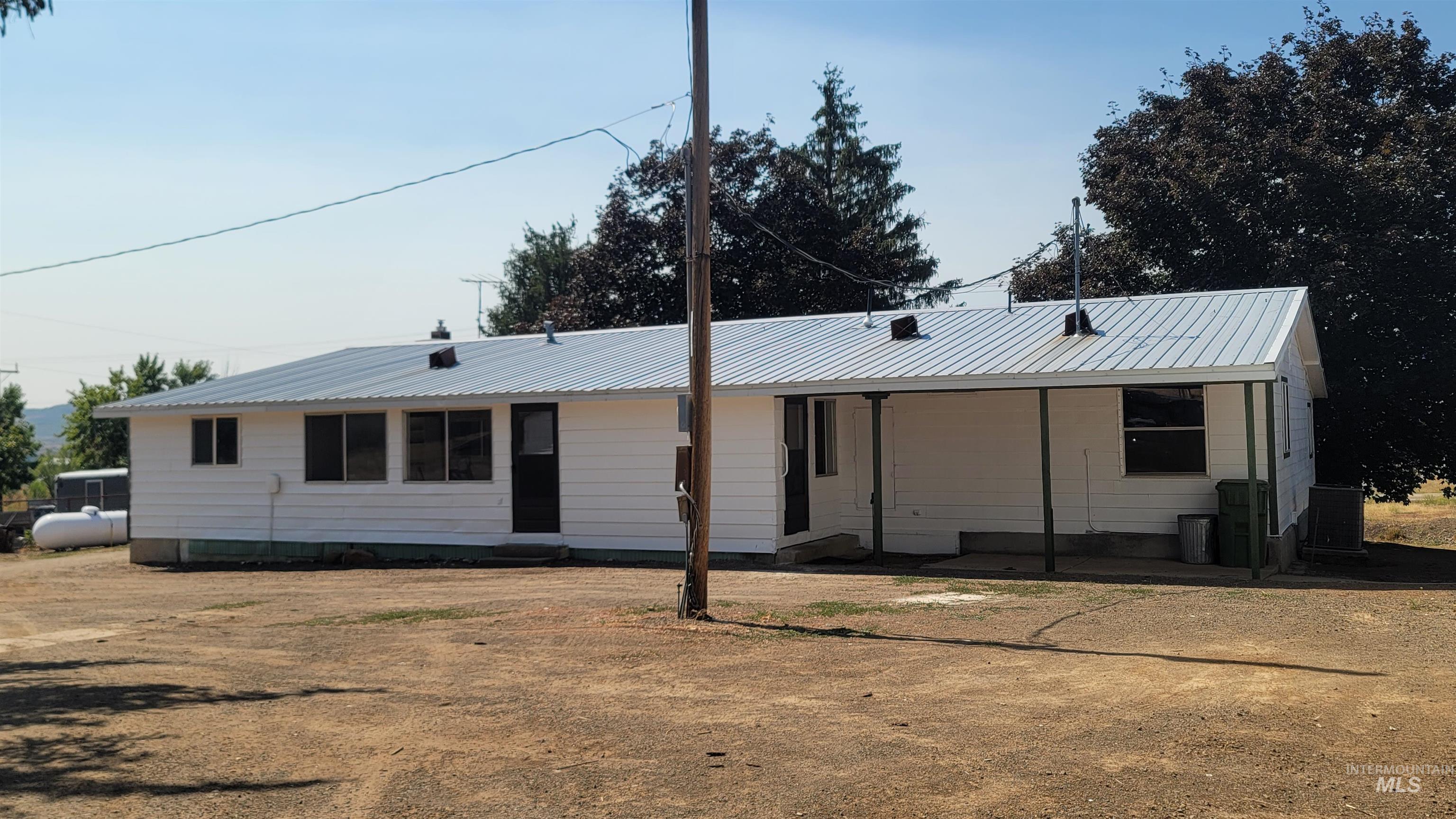 2122 Highway 95 Council, ID 83612 - Photo 3 of 31 View of front of house with a metal roof and crawl space