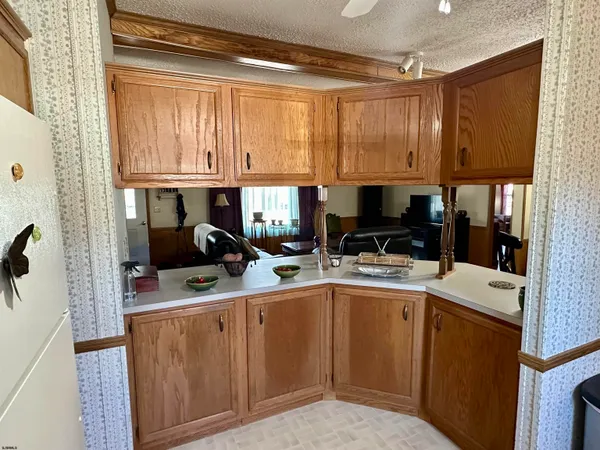 a kitchen with a sink cabinets and a window