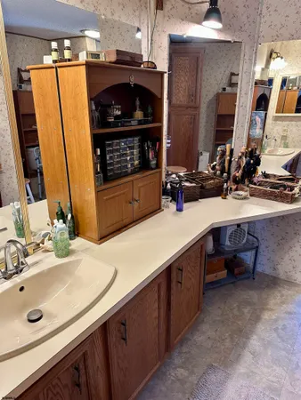 a bathroom with double vanity and a mirror