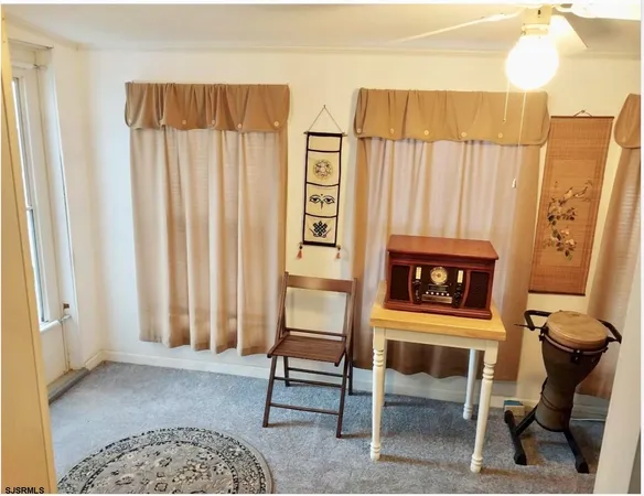 a living room with furniture a rug and a window