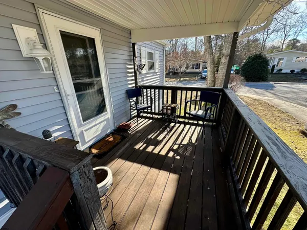 a view of a balcony with wooden floor