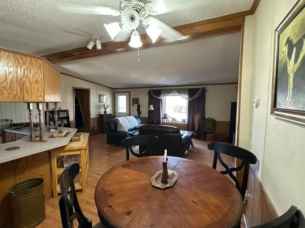 a living room with dining room and wooden floor