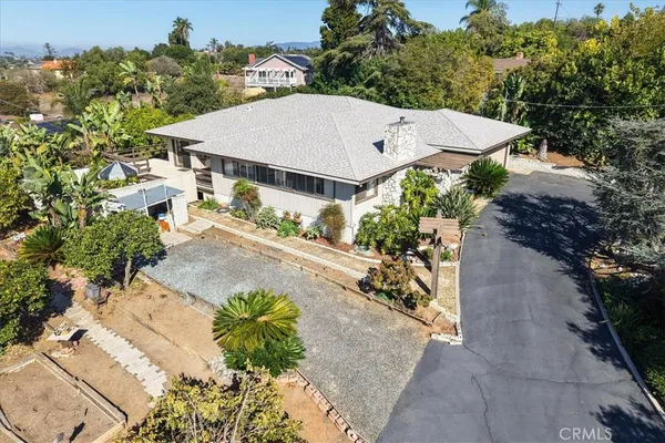 an aerial view of a house with a yard and potted plants