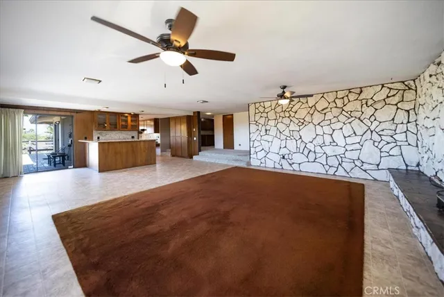 a kitchen with stainless steel appliances granite countertop a refrigerator a sink and a stove