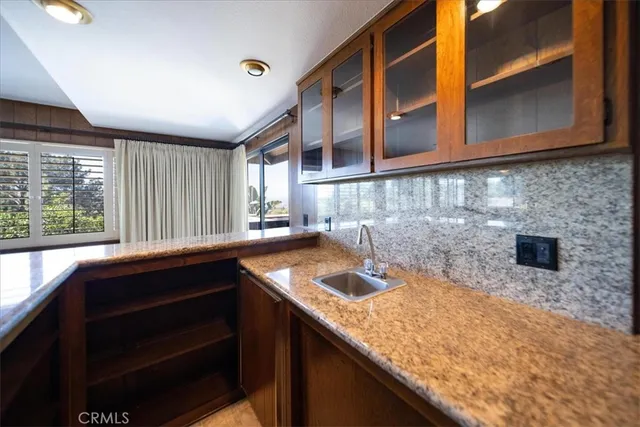 a large kitchen with a large window and stainless steel appliances