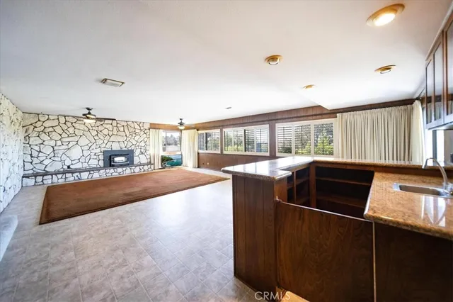 a kitchen with granite countertop a sink stainless steel appliances and cabinets