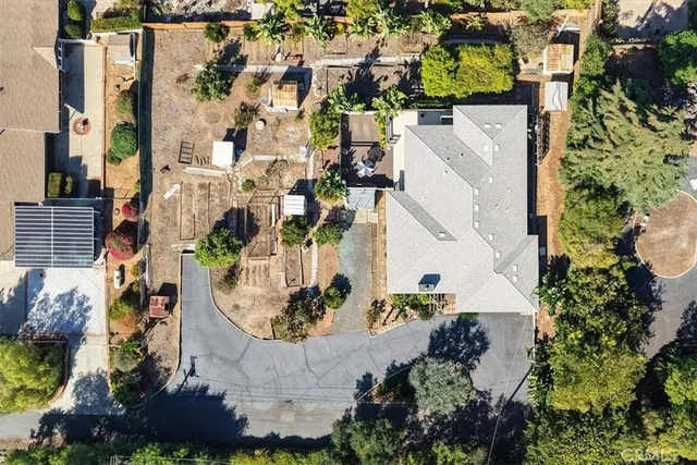 an aerial view of a house with a yard and lake view