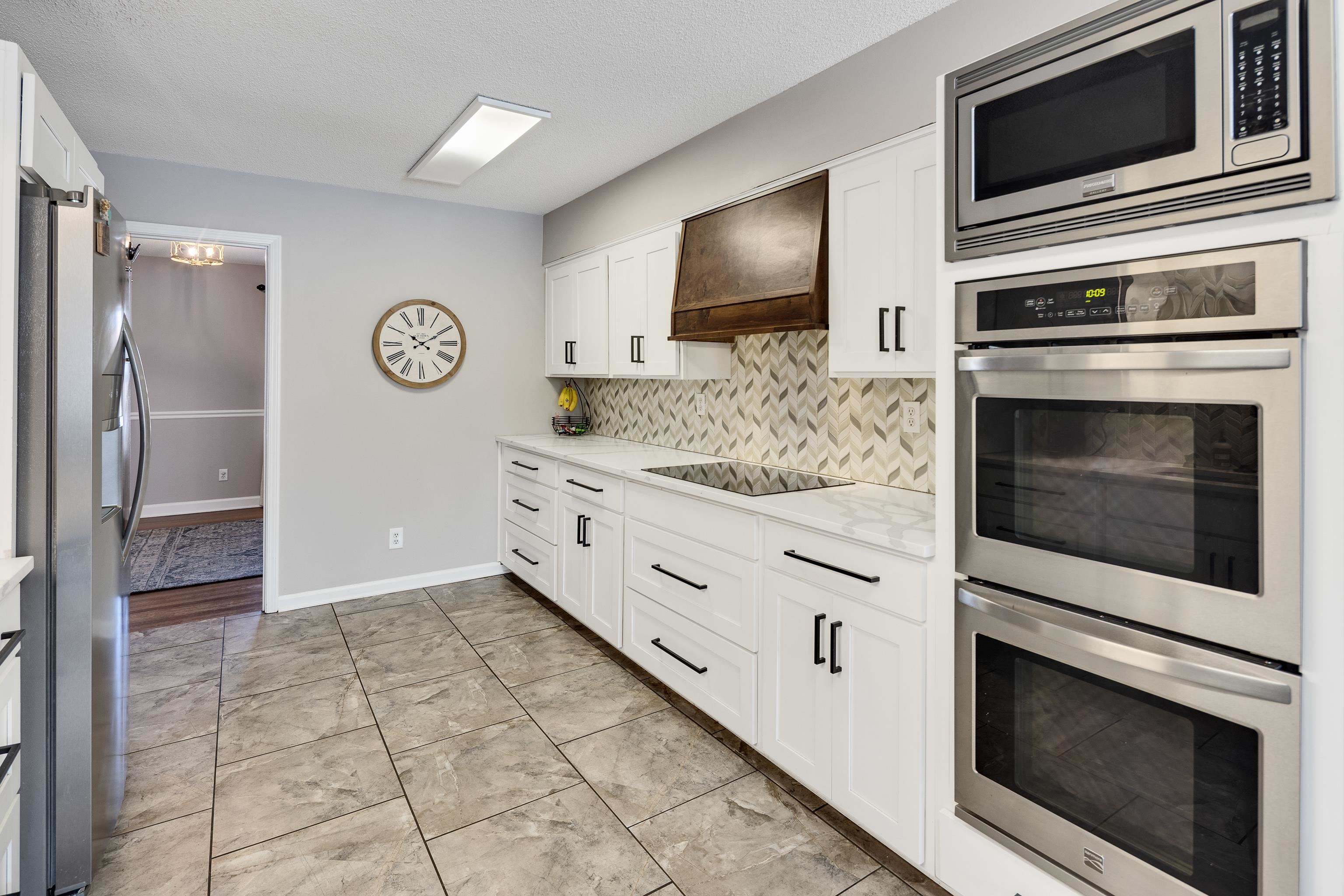 3888 Appling Road Bartlett, TN 38135 - Photo 11 of 21 a kitchen with stainless steel appliances kitchen island granite countertop a stove a microwave and a refrigerator