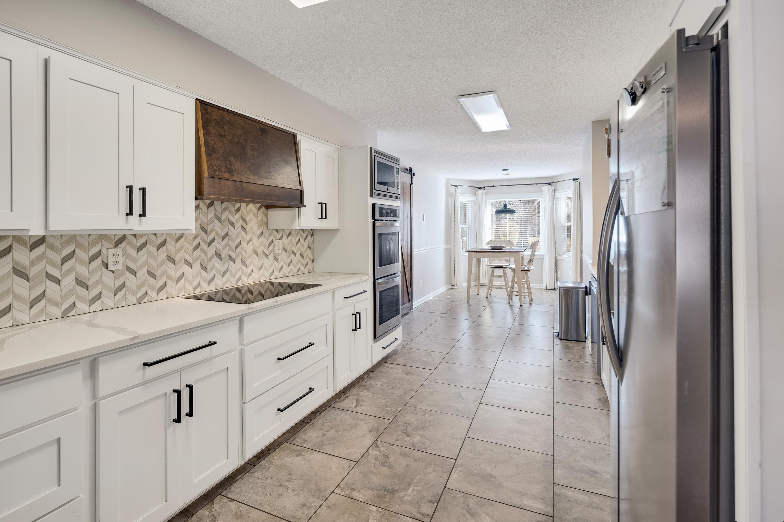 3888 Appling Road Bartlett, TN 38135 - Photo 9 of 21 a kitchen with granite countertop a refrigerator and cabinets